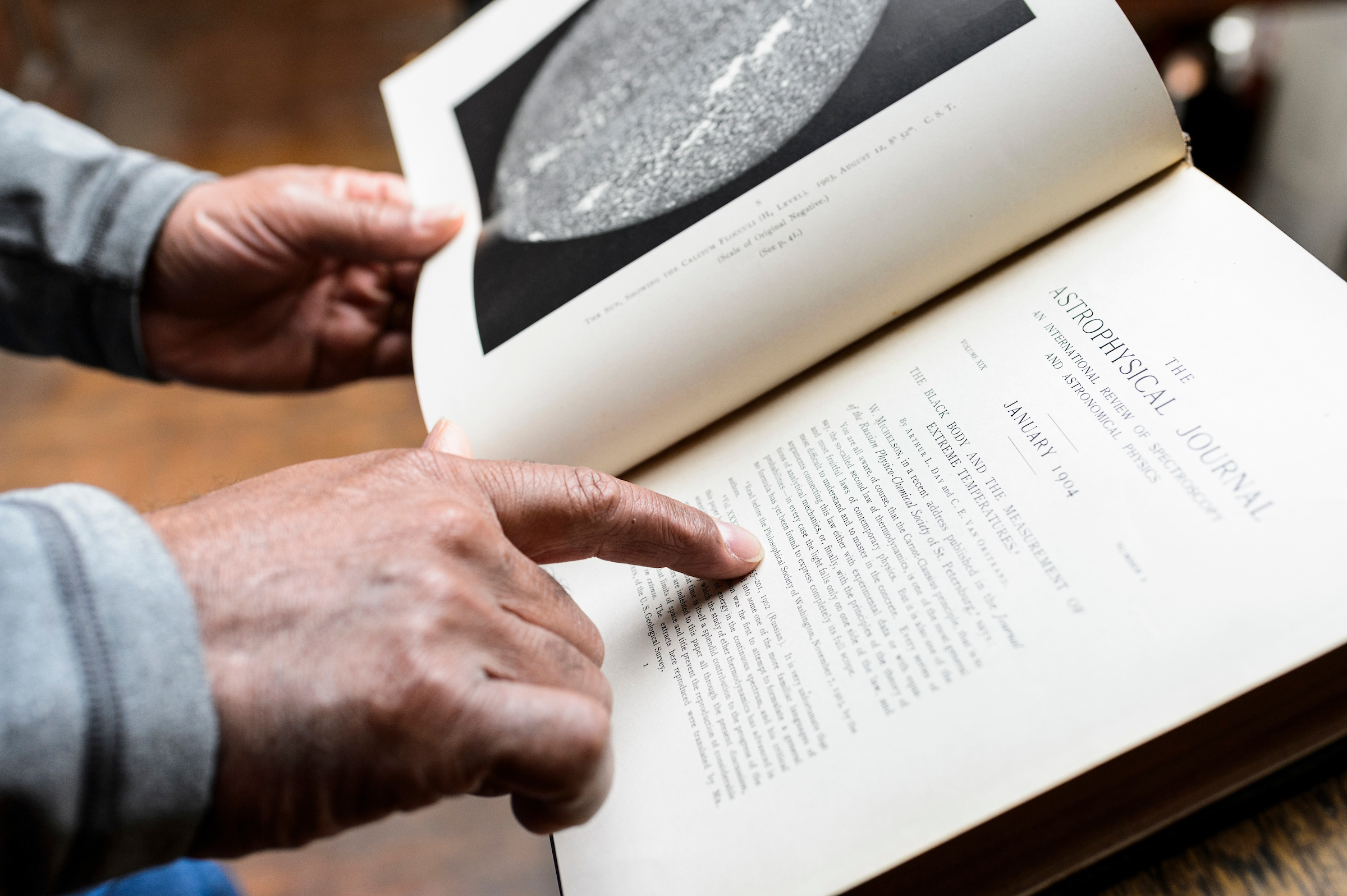 photo of a older man's hands with a book