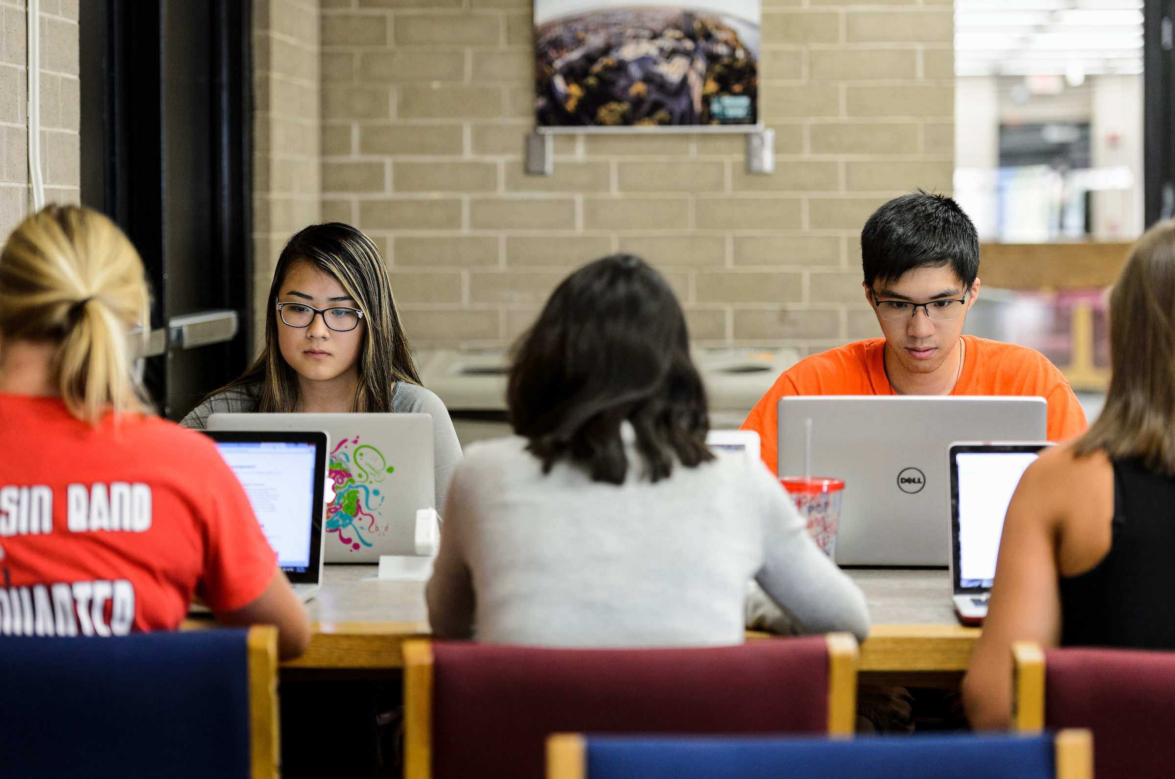 photo of students with lap tops around a table