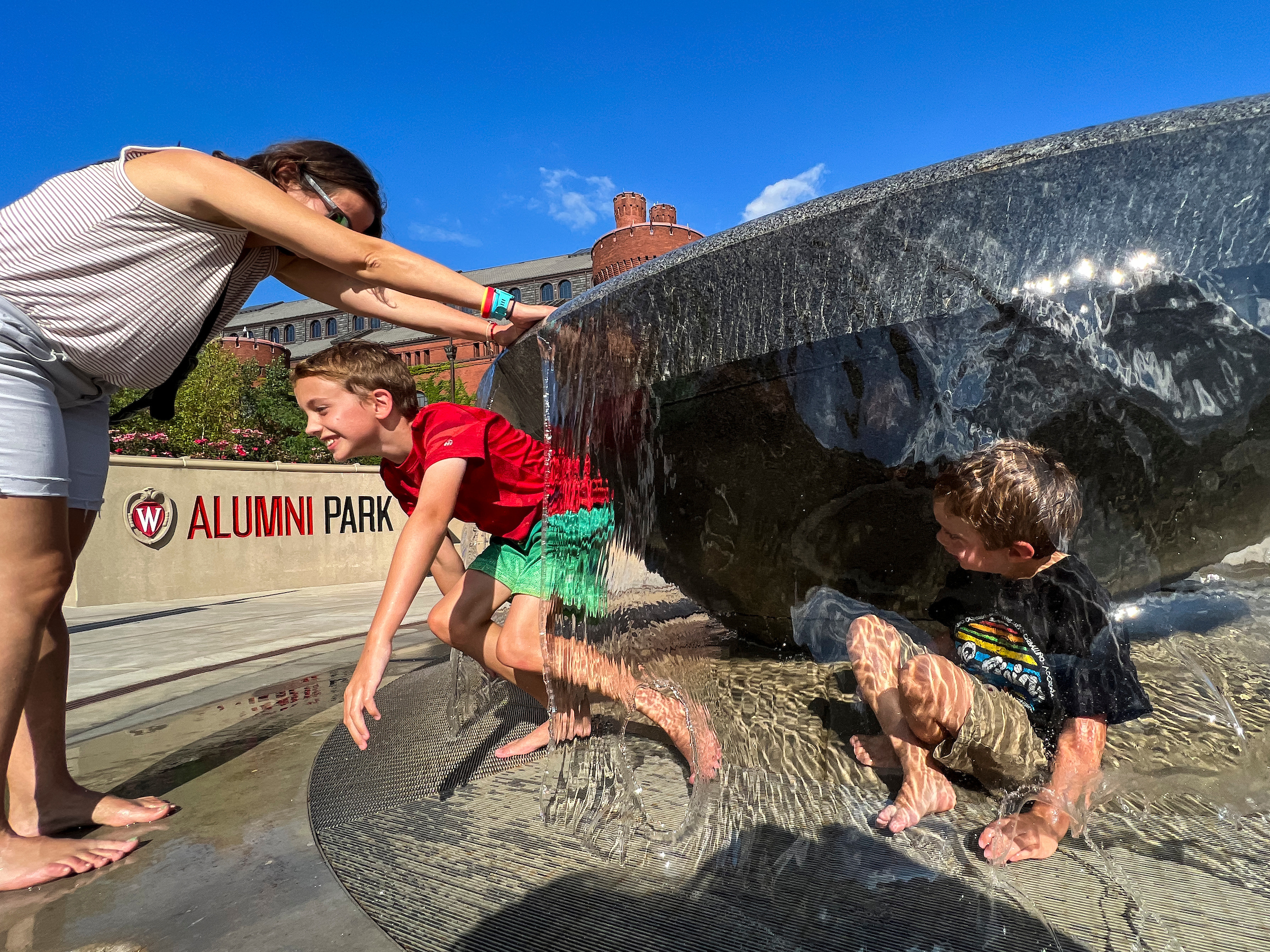 picture of a family playing in the alumni fountain