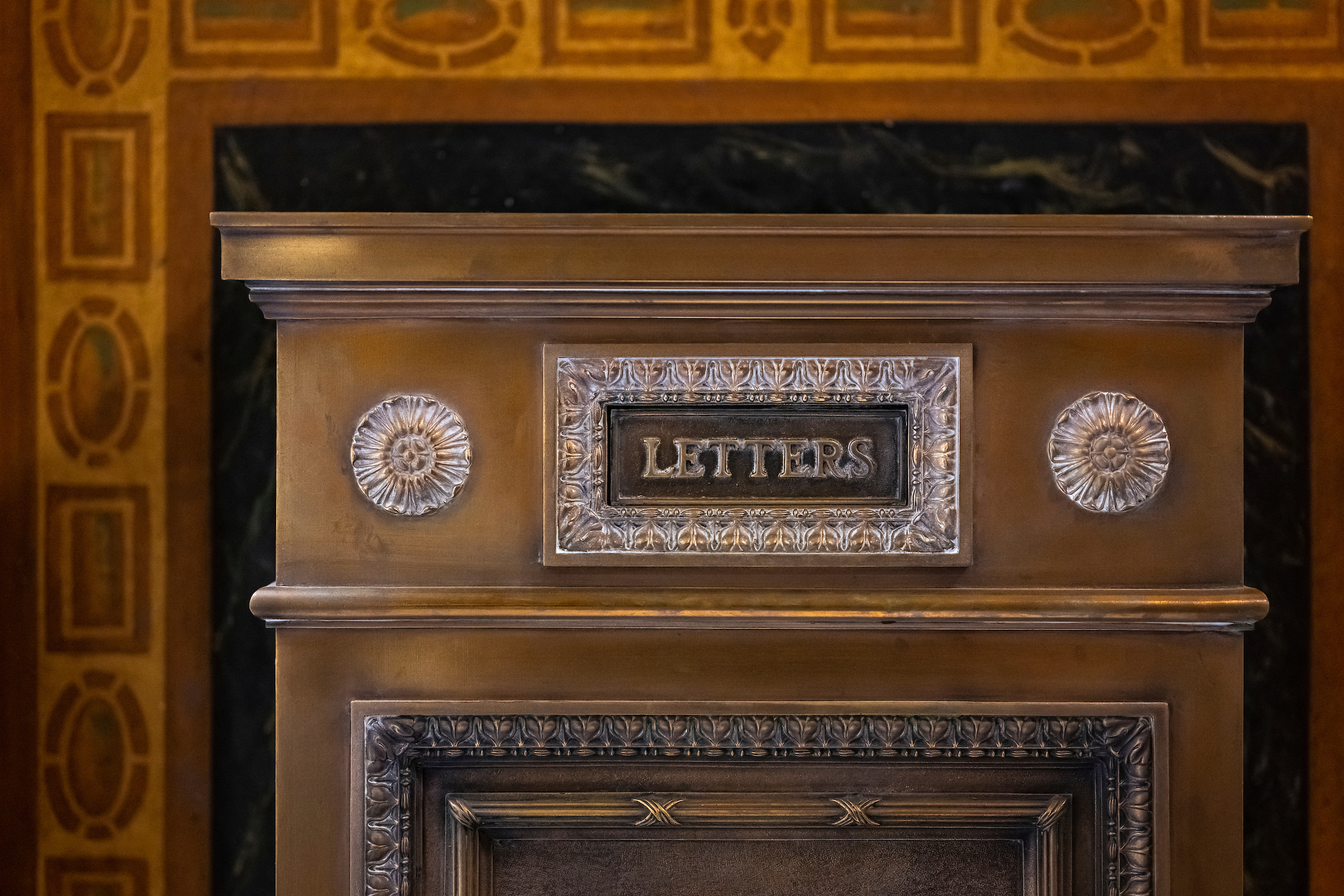 A vintage, bronze-drop box for mailing letter.