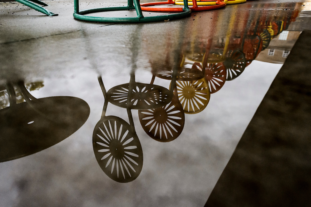 reflection of terrace chairs after a storm