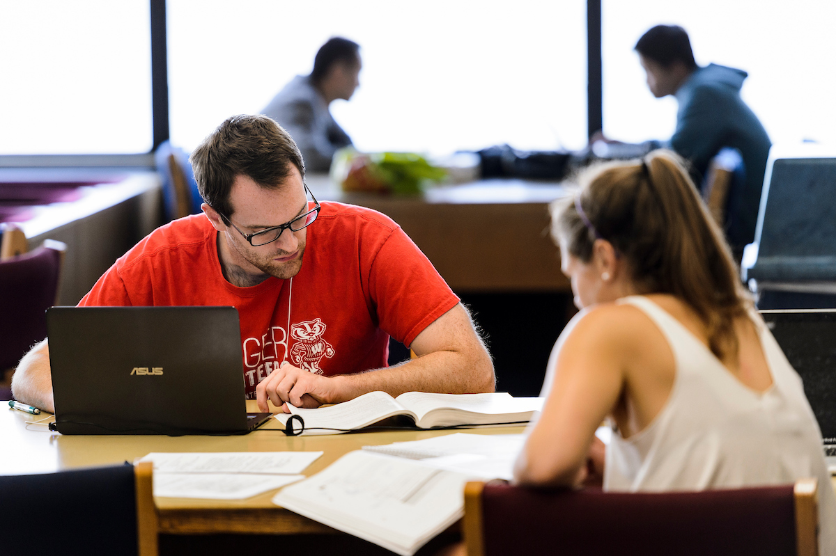 two students studying in the library
