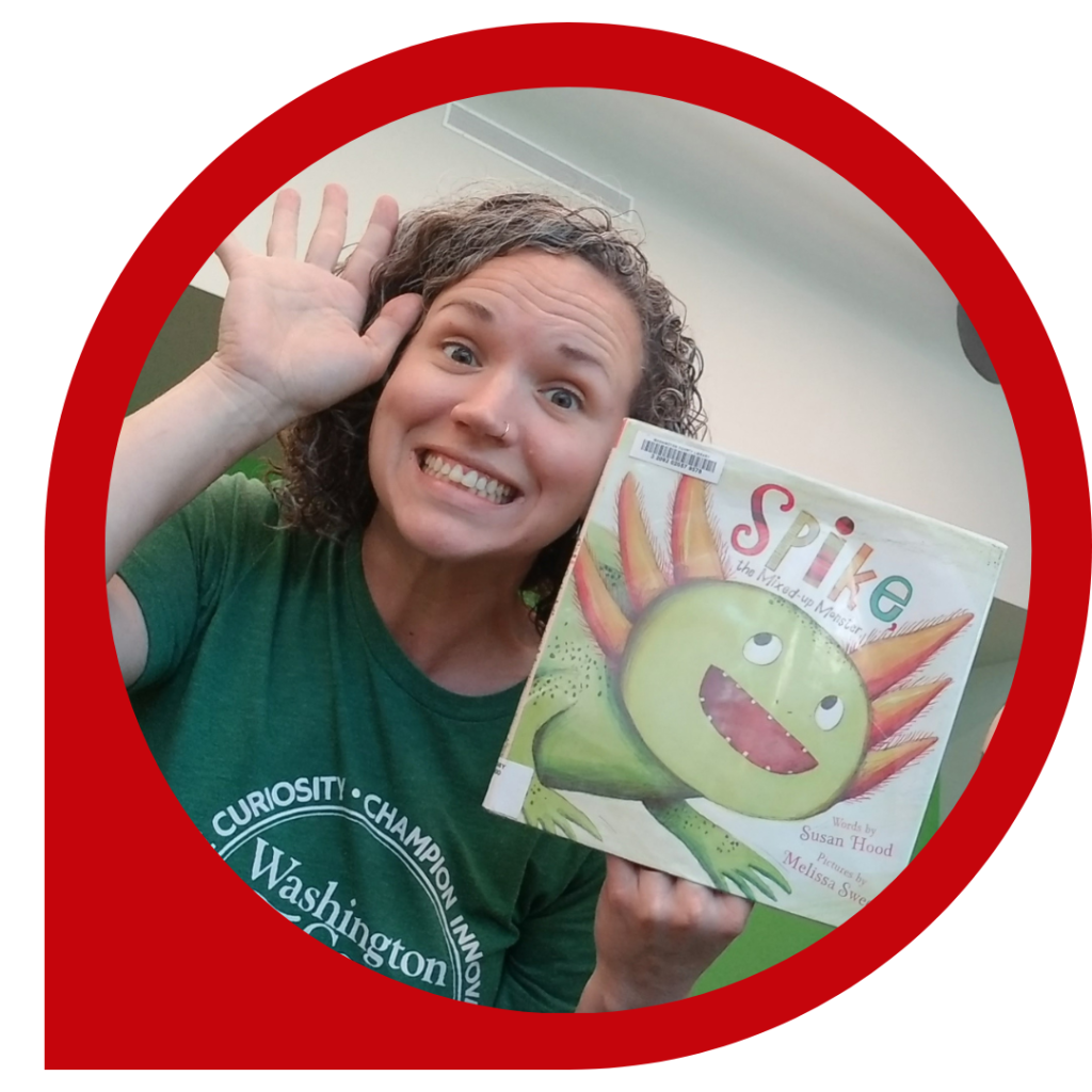 Katelyn with a picture book called Spike the Mixed-up Monster with a green lizard monster looking creature on the front cover