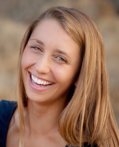 woman brown/blonde hair dark blue shirt