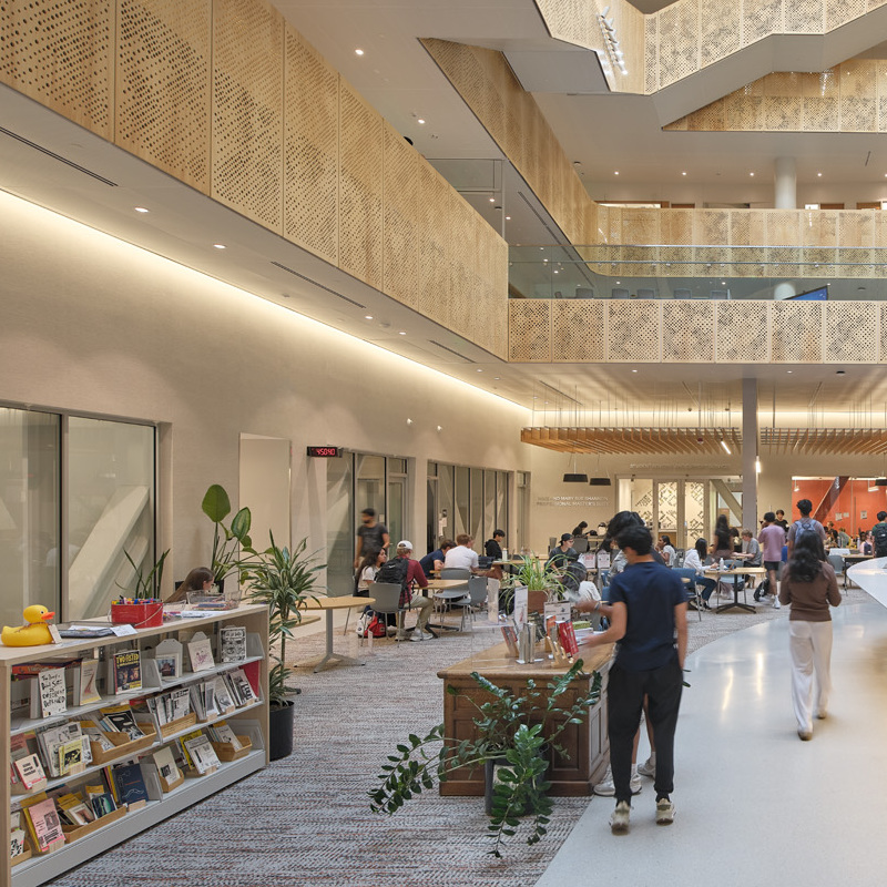 Open, lit library space with students browsing