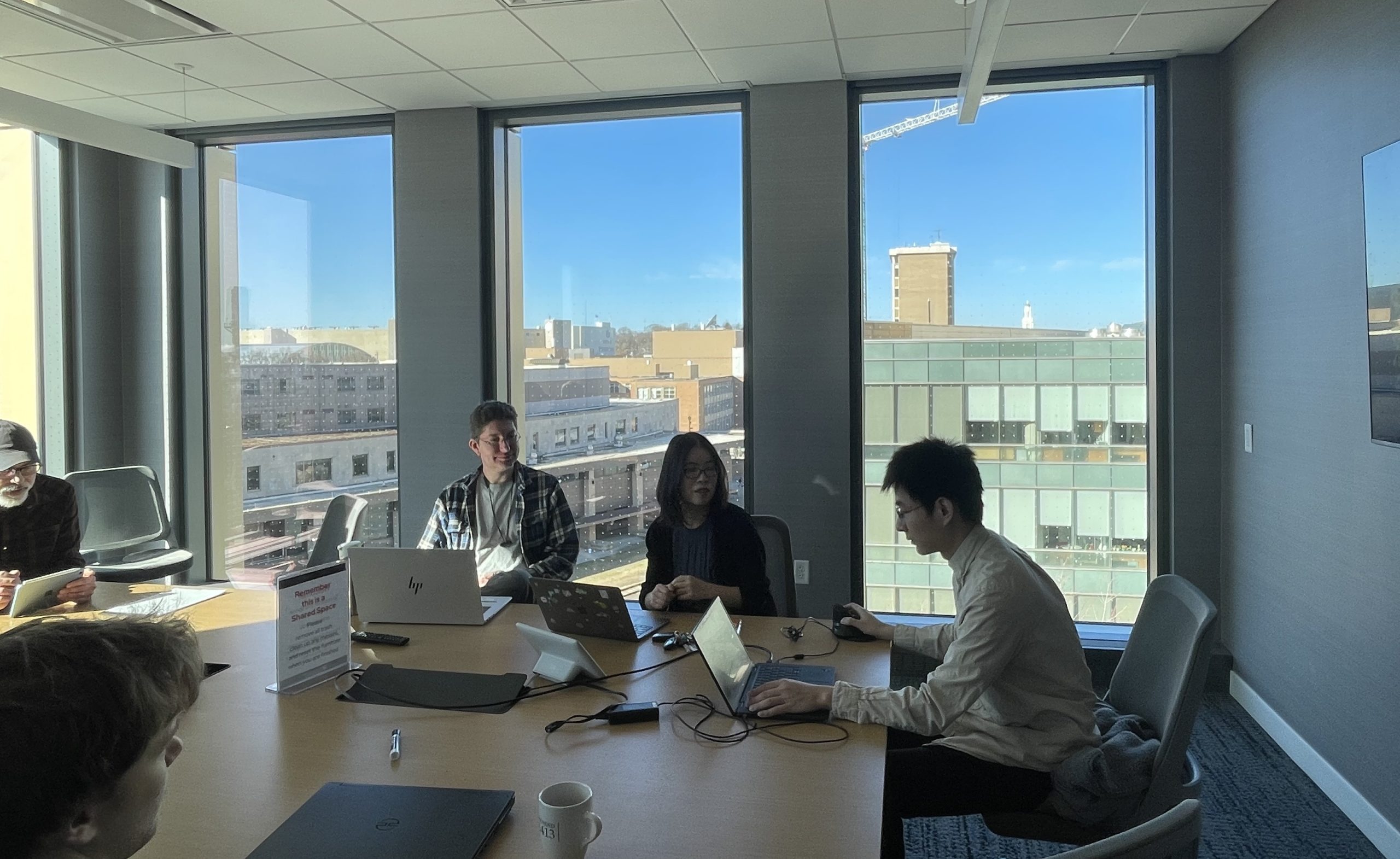 Three researchers meeting in conference room with sublight