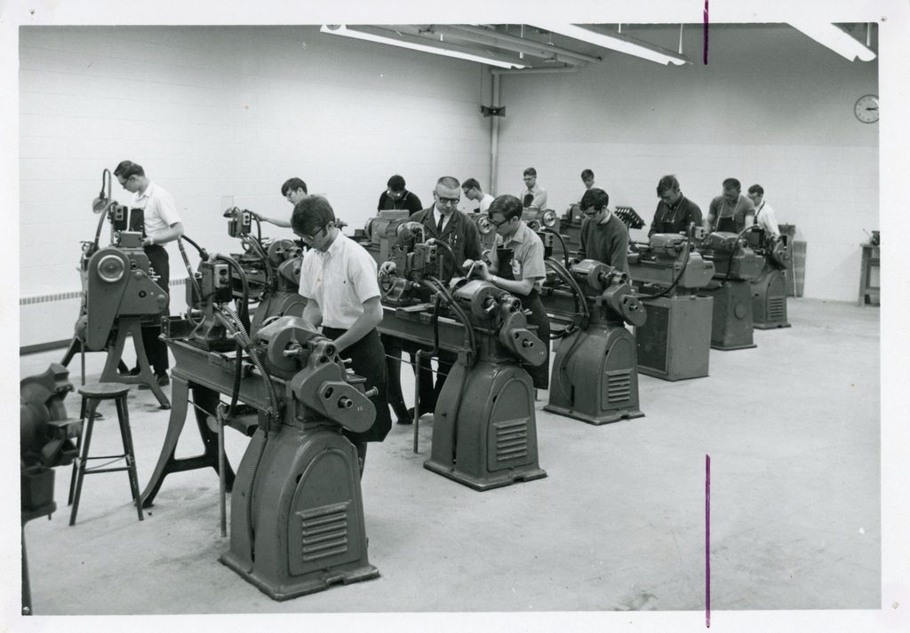Old photo of people working on machines