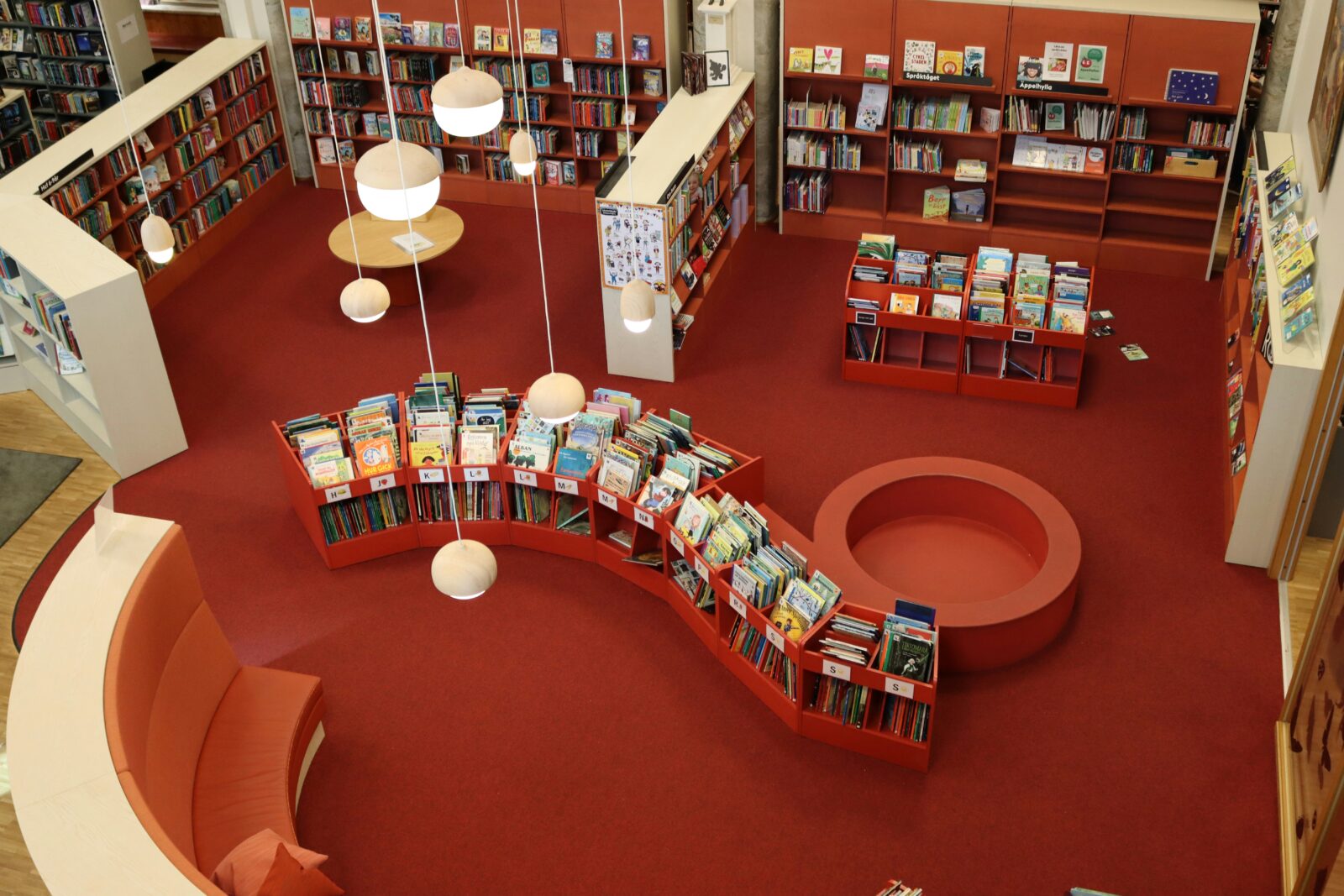 Public library youth section curvy booking shelving for picture books